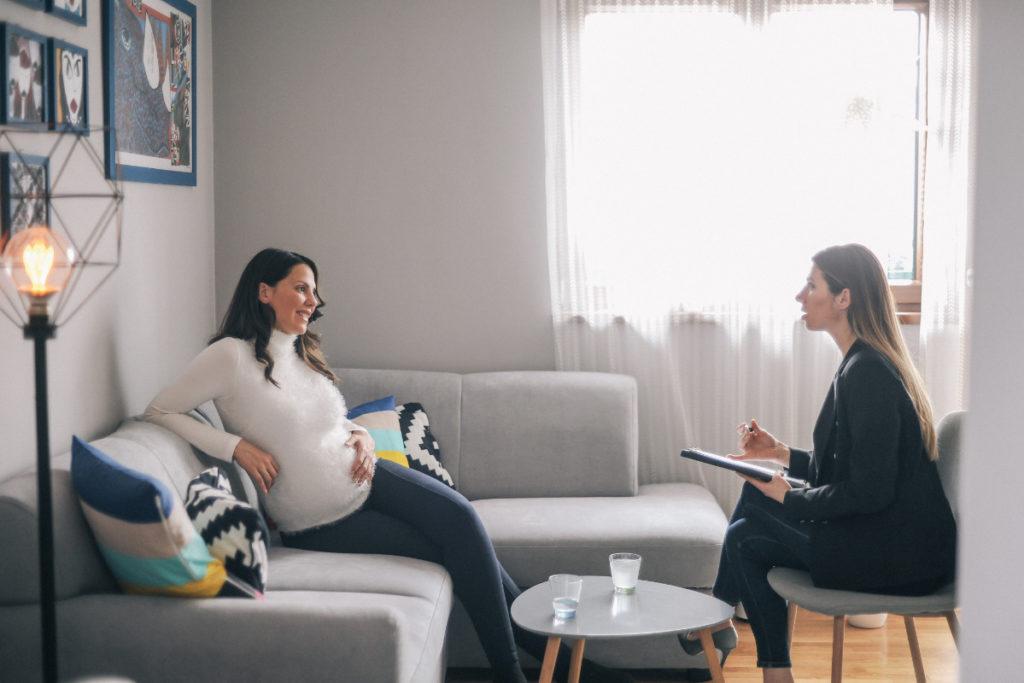 Pregnant woman meeting the counsellor at home